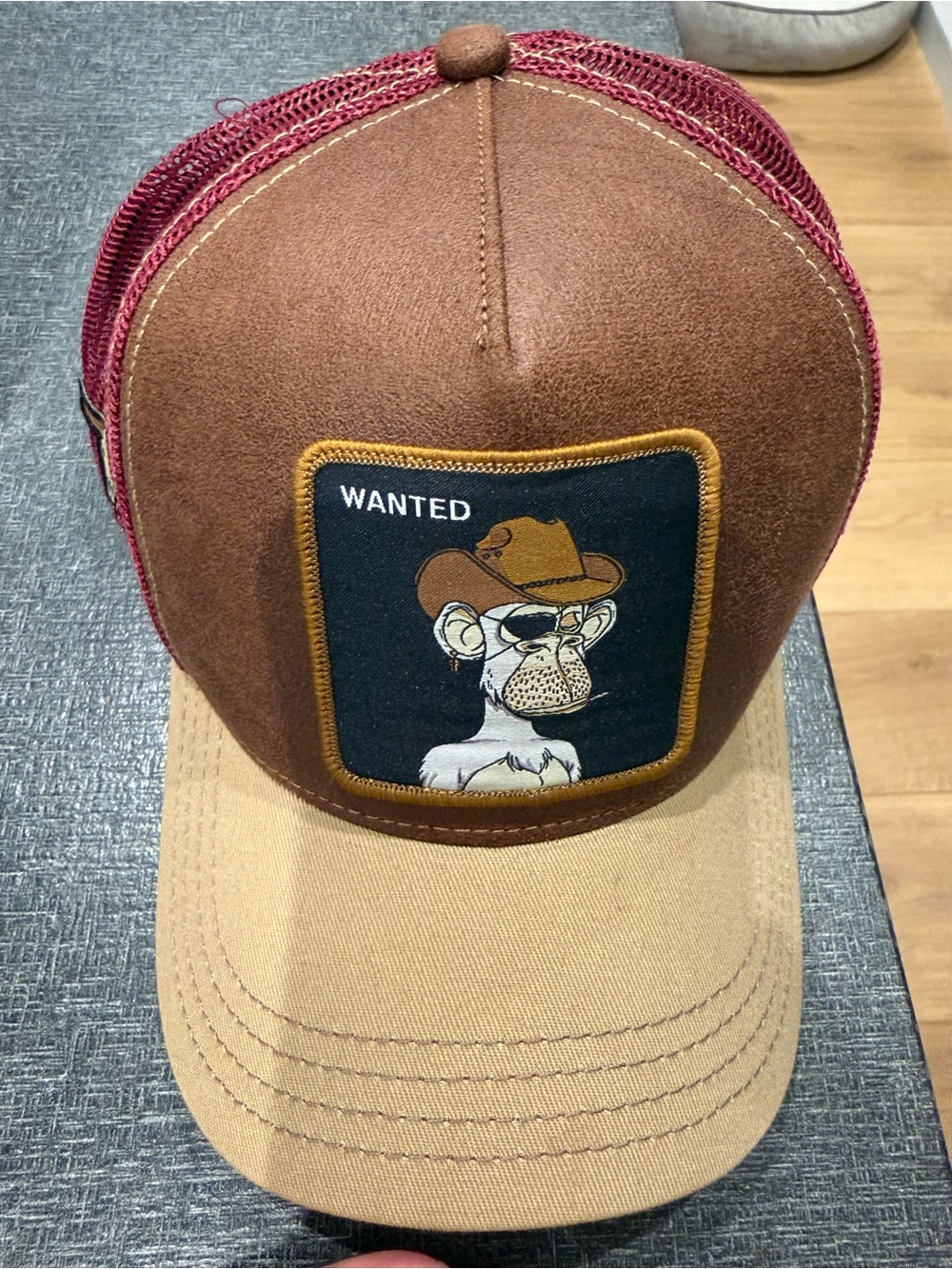 Brown and Tan Trucker Hat with Embroidered 'Wanted' Patch
